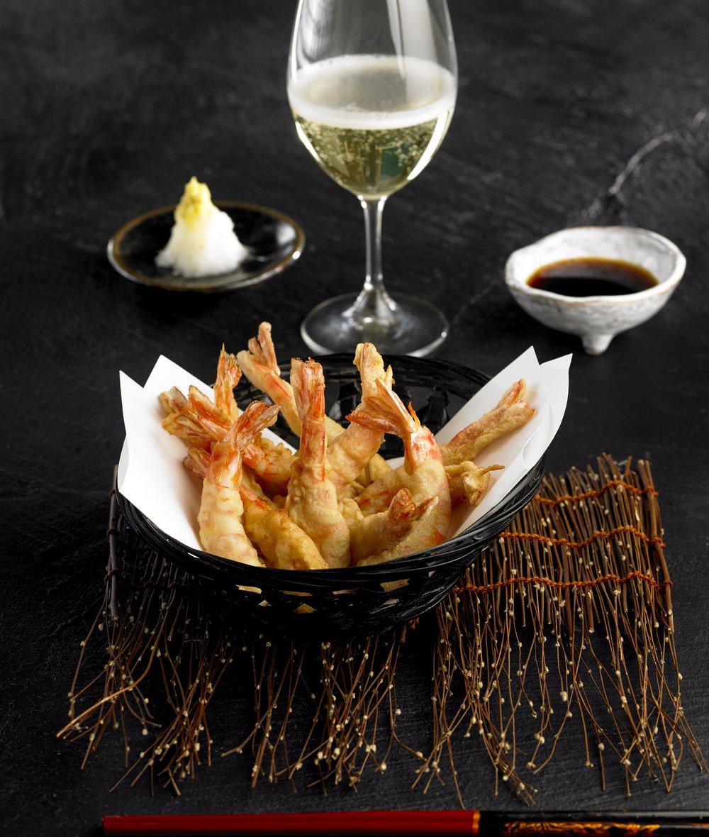 Overhead shot of a plate of calamansi tempura with honey, ready to be served