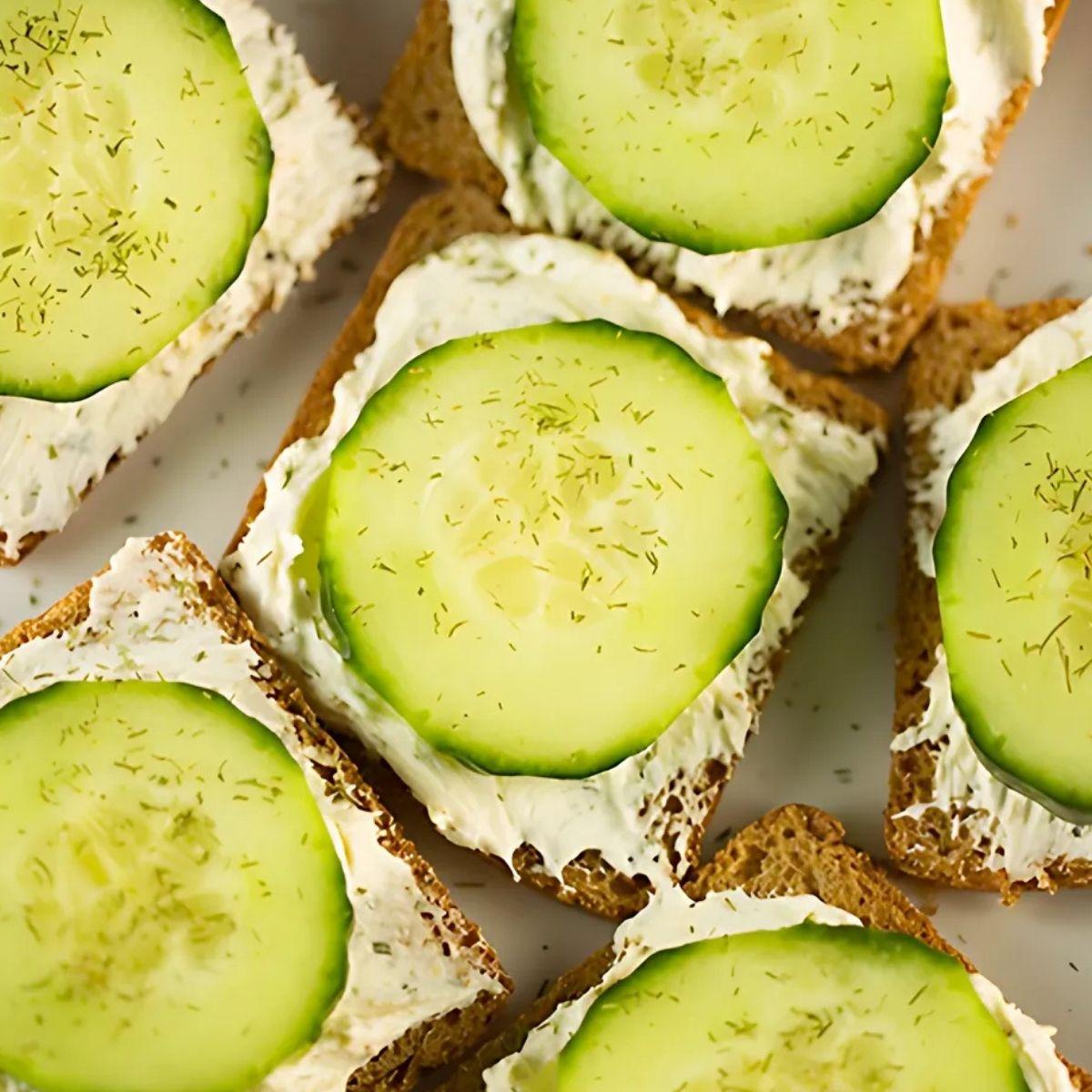 Close-up of the creamy dill cucumber salad being spread on rye bread