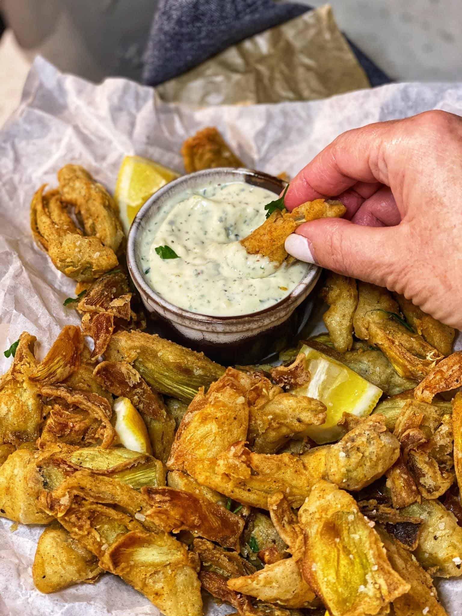 Crispy tempura-fried artichoke hearts with a vibrant lemon-herb dipping sauce