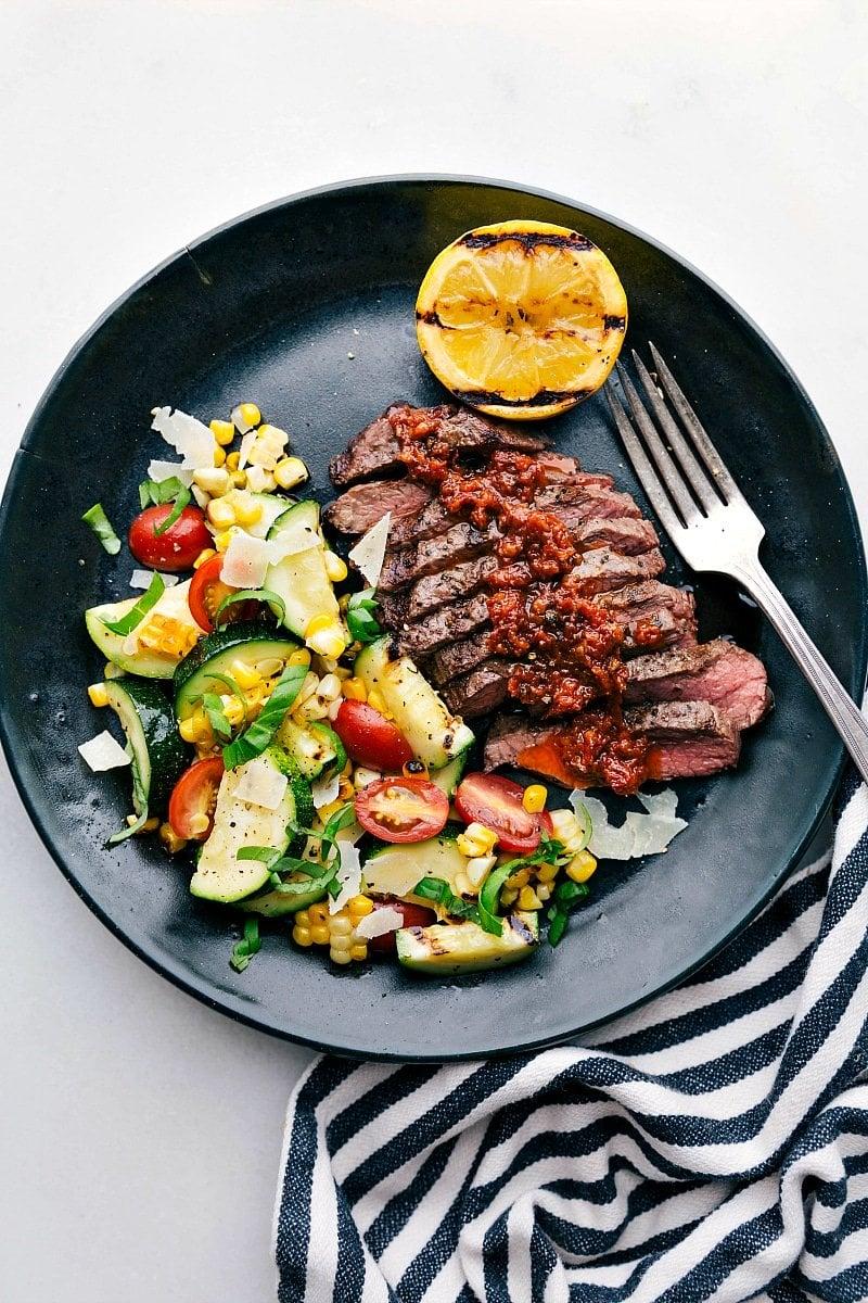Grilled steak with zucchini and a side salad