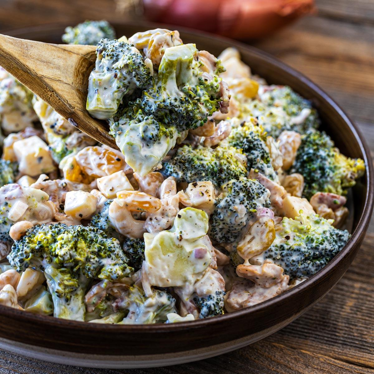 A wider shot of the BBQ broccoli salad served at a party or barbecue.