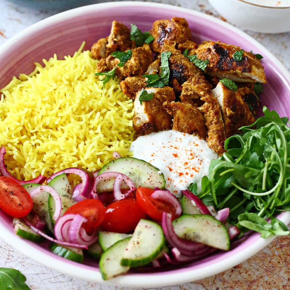 A close-up shot of the Shawarma-Inspired Chicken and Rice Casserole, showing the texture and color of the chicken and rice