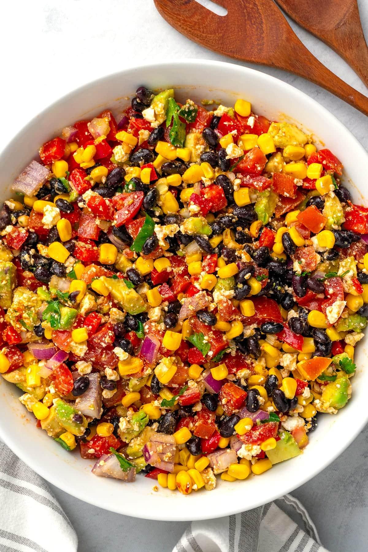A vibrant, colorful bowl of Spicy Wheat Salad with Black Beans and Corn, garnished with fresh cilantro.