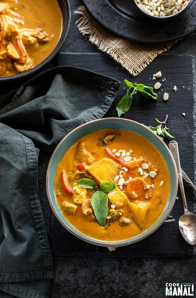 A person enjoying a bowl of vegan Panang curry