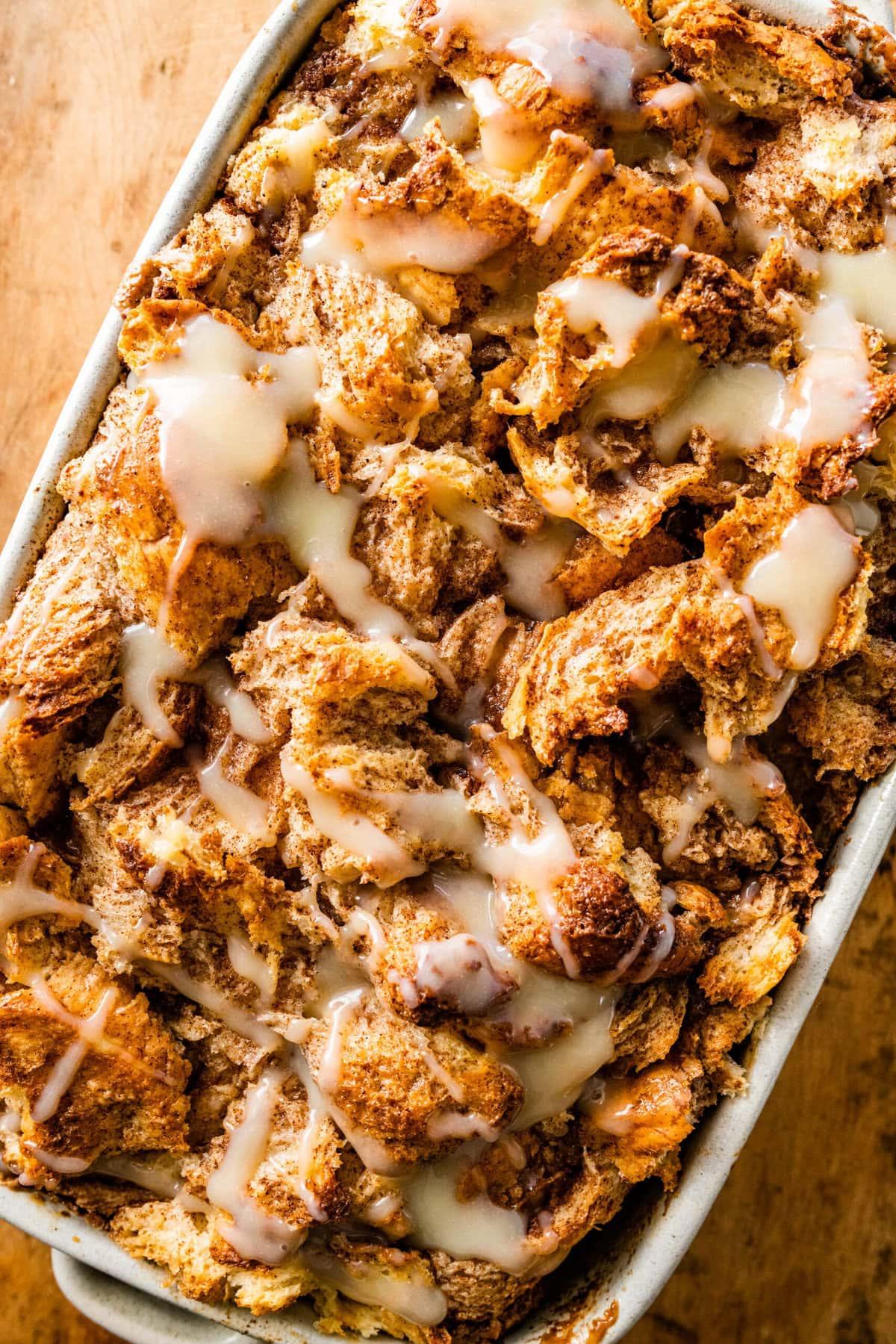 A rustic, golden-brown bread pudding with a slightly crispy top, served warm in a baking dish