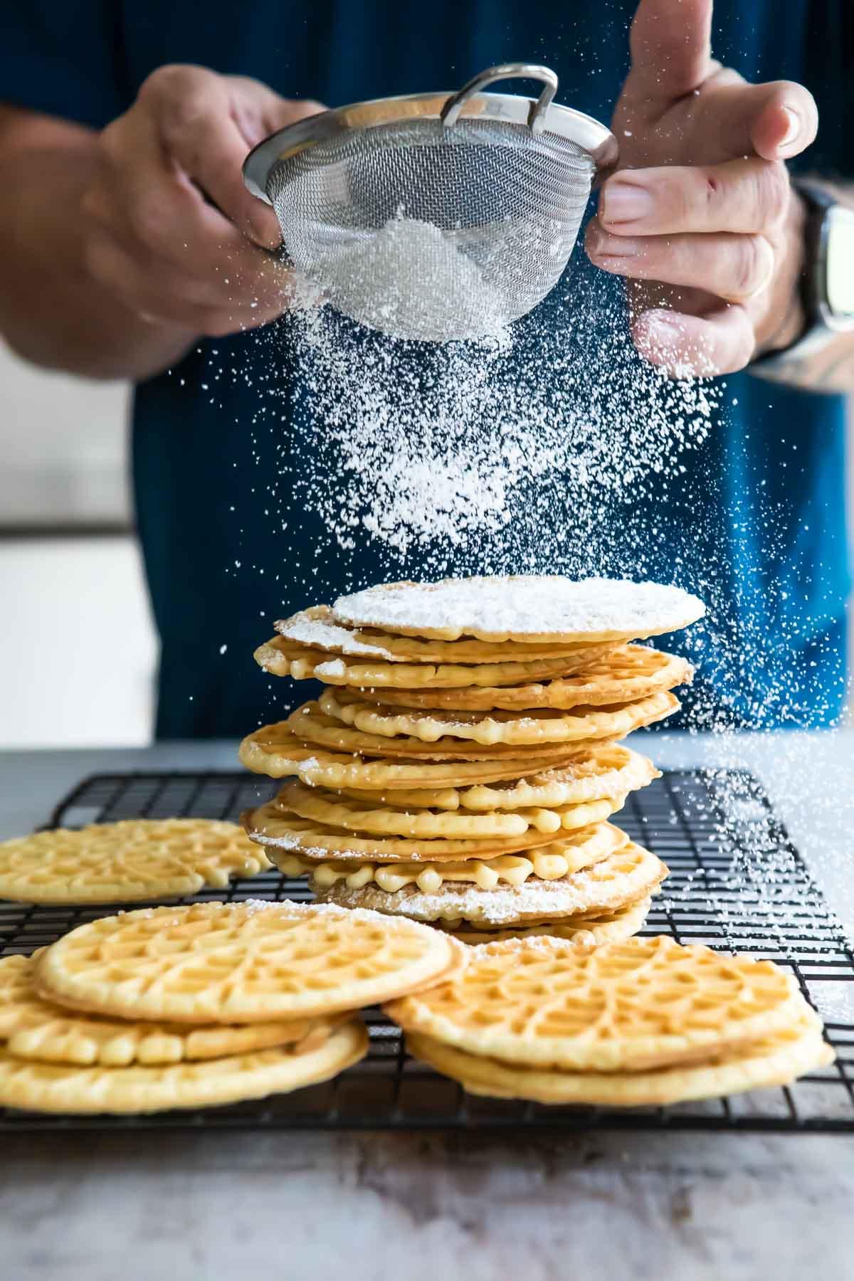 a modern-day kitchen scene with someone making pizzelle cookies