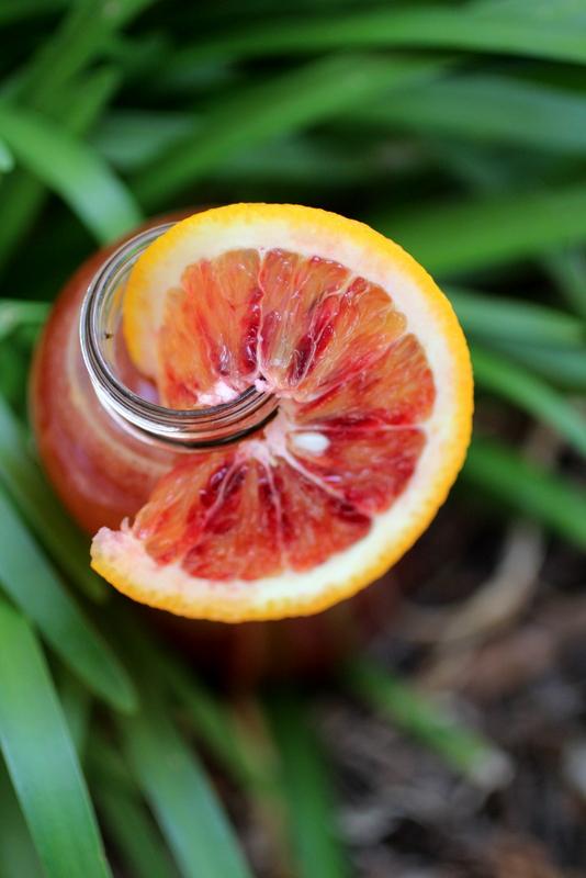Close-up of a glass of Blood Orange Kombucha Sunset with condensation