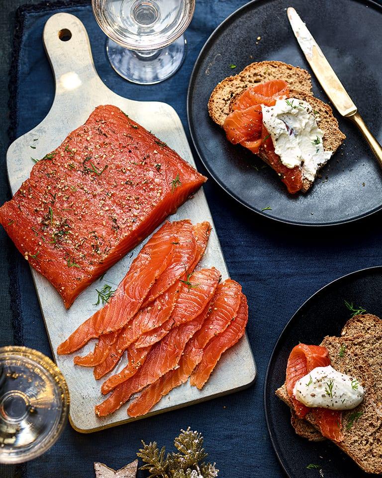 A beautifully plated dish of Black Pepper & Rye Gravlax with Horseradish Cream, showcasing the texture and color.