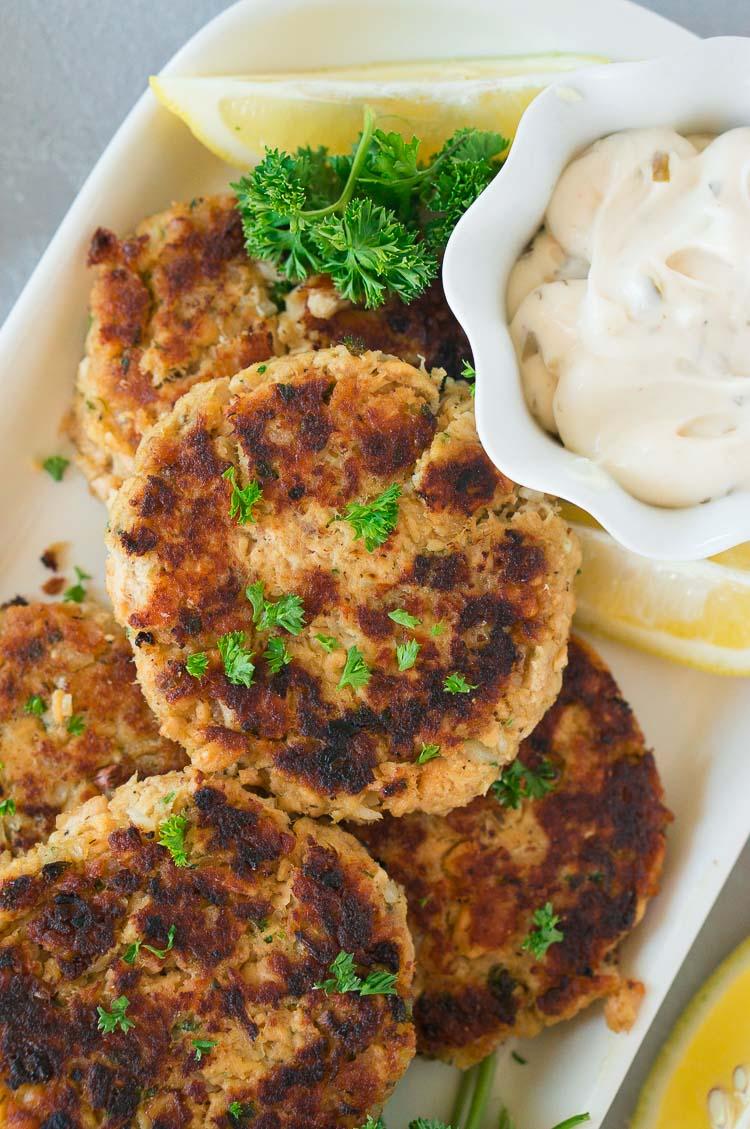Close-up of perfectly browned salmon patties on a baking sheet