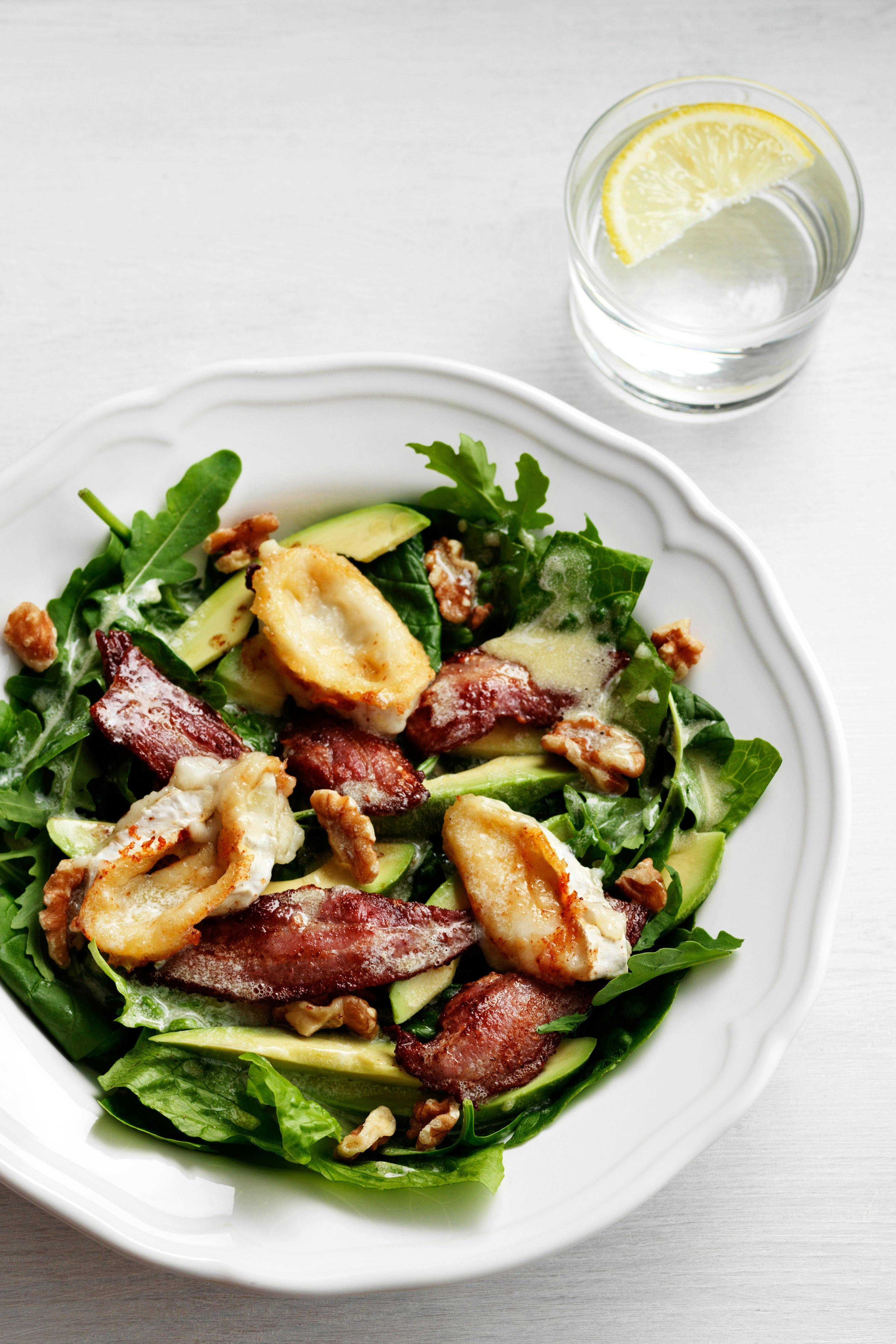 Close-up shot of a vibrant Keto Avocado Salad with creamy goat cheese, showing the textures and colors of the ingredients.