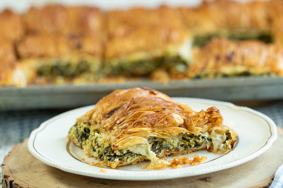 Close-up shot of a piece of spanakopita being served
