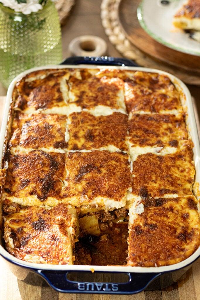 A golden-brown, perfectly layered one-pan moussaka in a rustic baking dish
