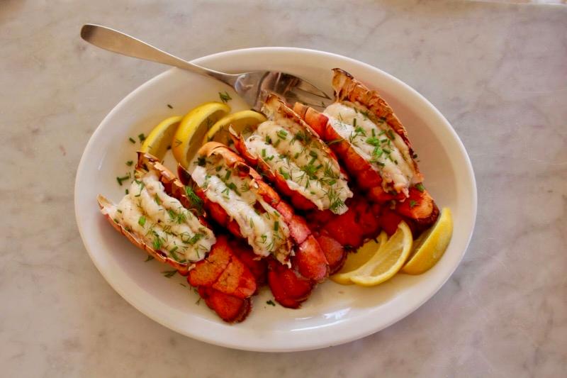 A couple enjoying a romantic dinner with Lobster with Anniversary Brown Butter