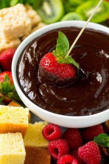 People dipping various treats into jasmine rice milk chocolate fondue
