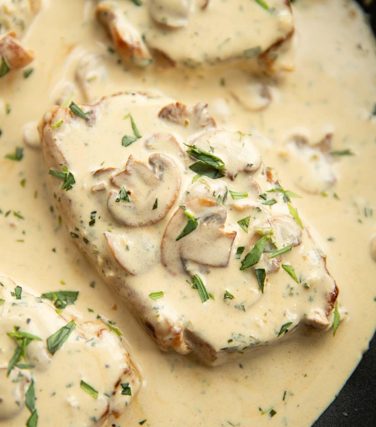 Close-up shot of sautéed mushrooms in a creamy tarragon sauce