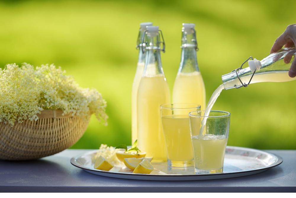 close up of elderflower cordial being poured into lemonade