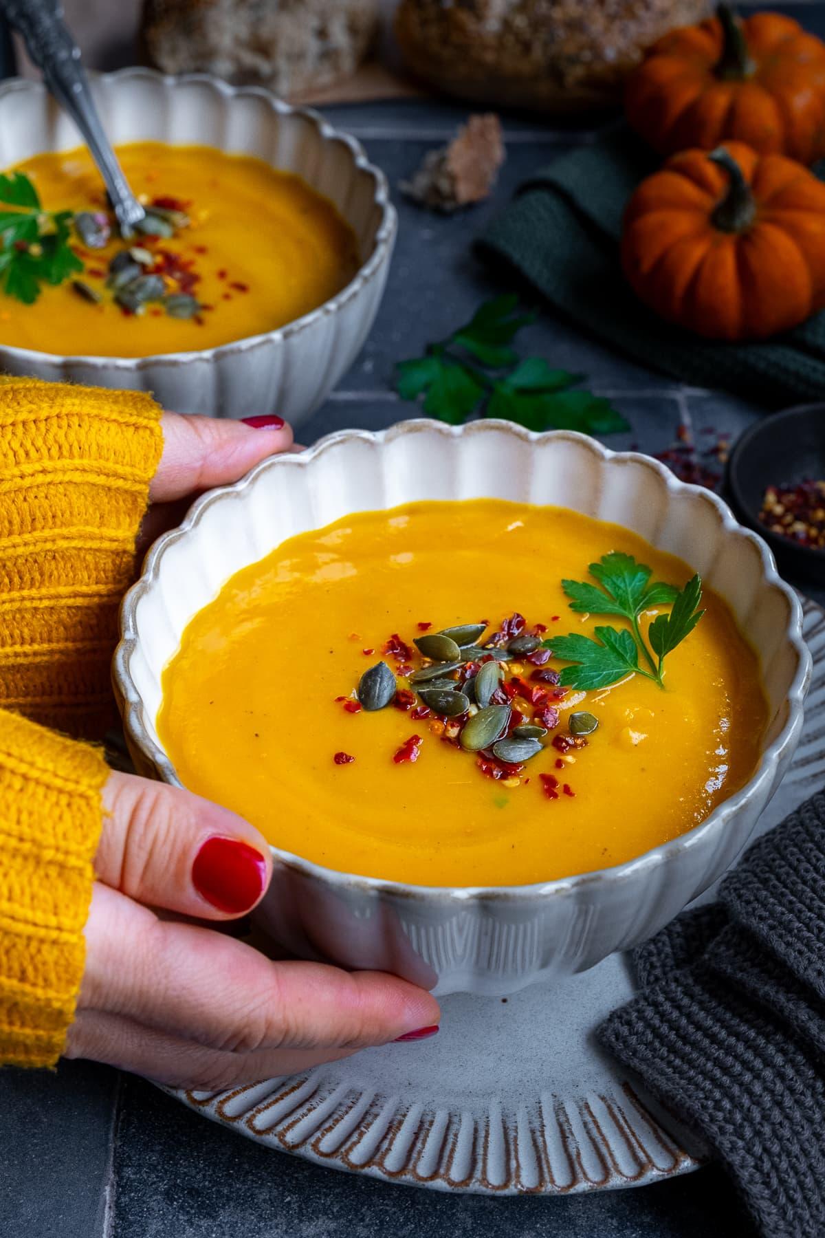 close up shot of pumpkin and sweet potato soup with curry garnish