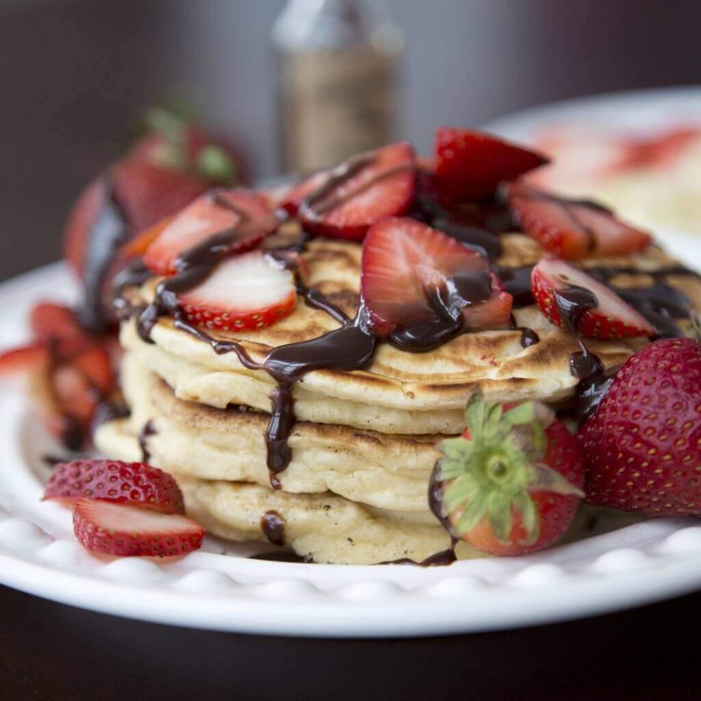 Close up of a plate of banana pancakes with Nutella