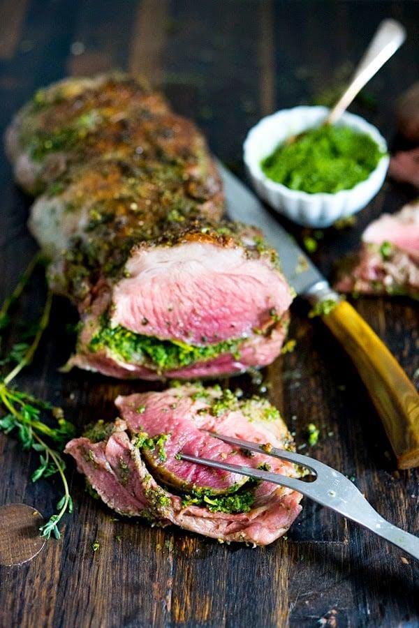 Close up of a roasted lamb leg with herbs