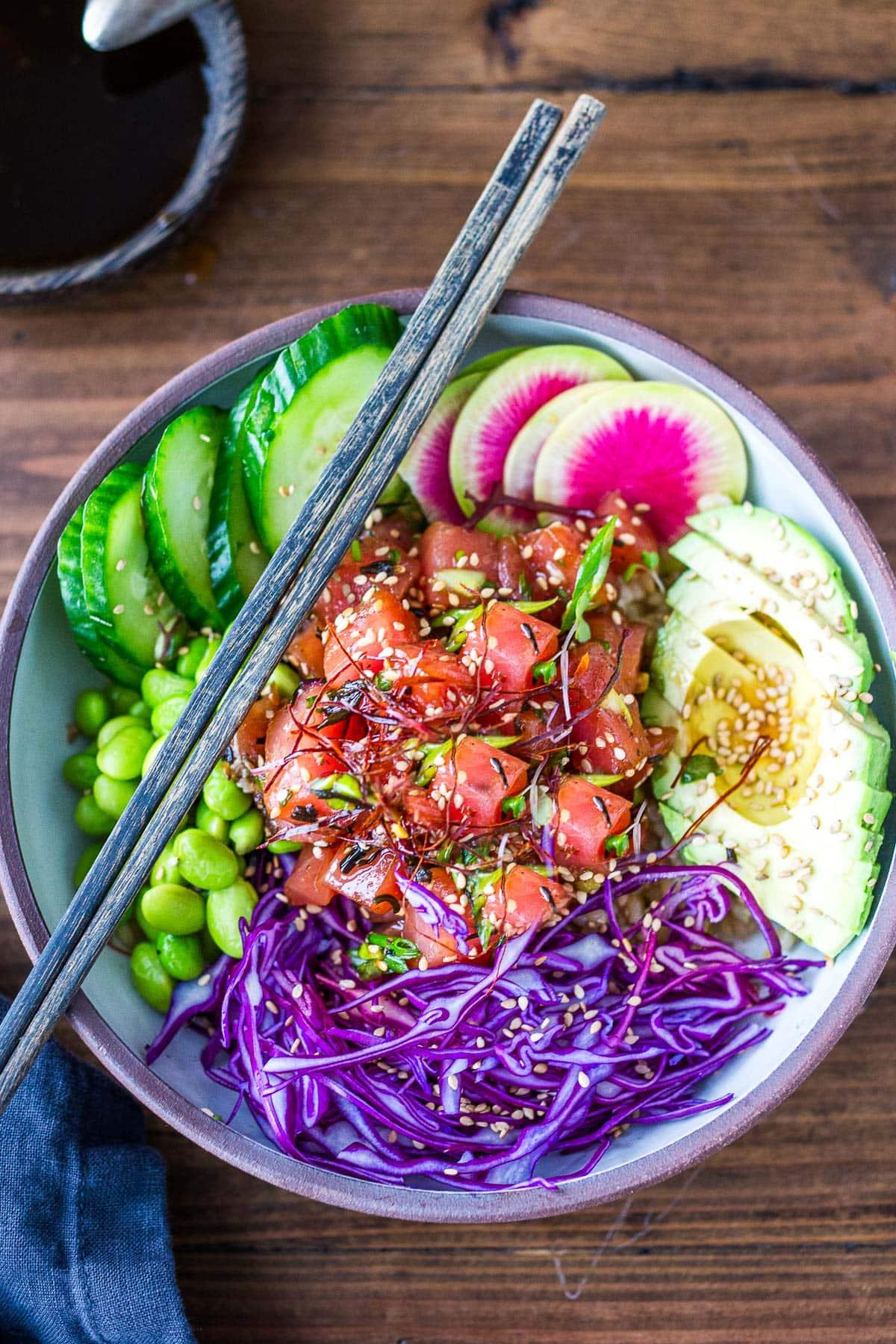 Colorful poke bowl with pickled ginger and seaweed salad