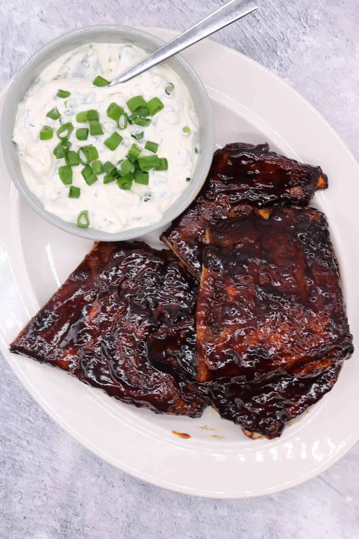 Platter of sliced smoked ribs with a generous dollop of Tintern and chive cream cheese on top