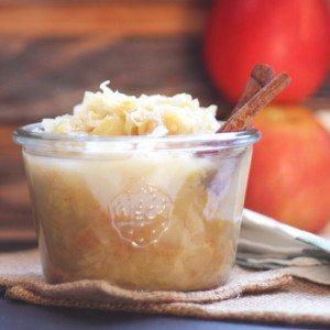 Close-up shot of a spoonful of sauerkraut and apple compote, showcasing its texture and color.