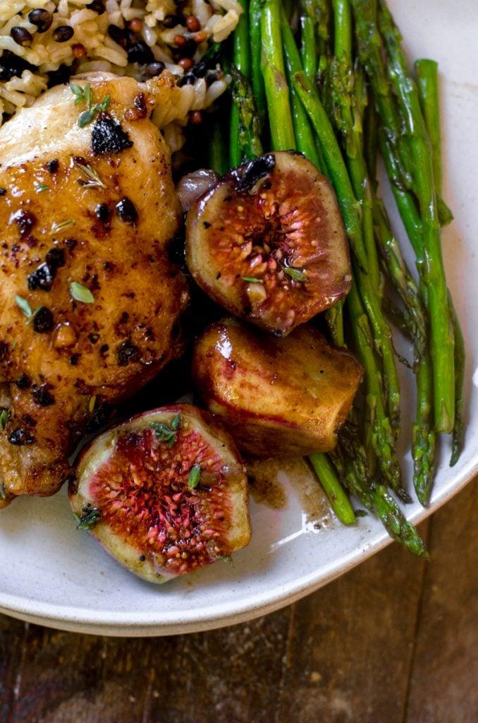 close-up of a slice of roasted chicken with figs and balsamic glaze