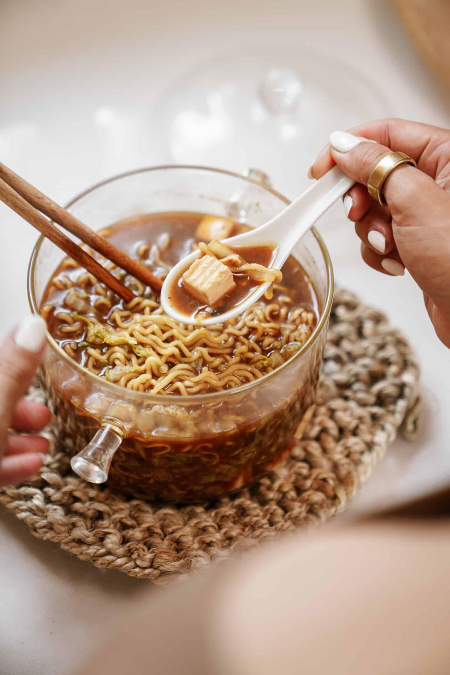 A person enjoying a bowl of Black Garlic Ramen