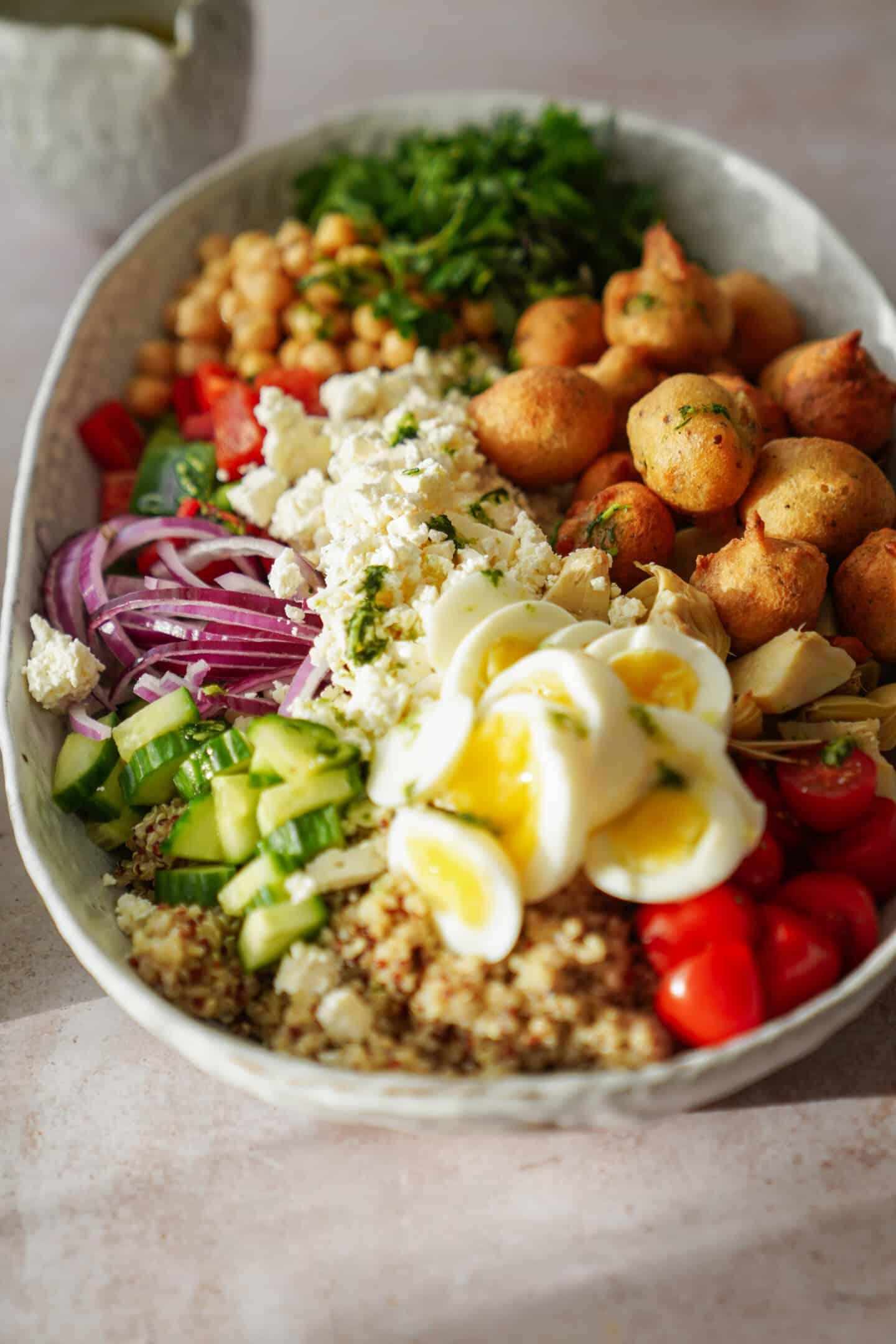 Close-up shot of a rustic bowl overflowing with Mediterranean Quinoa Salad, highlighting the vibrant colors of the ingredients.