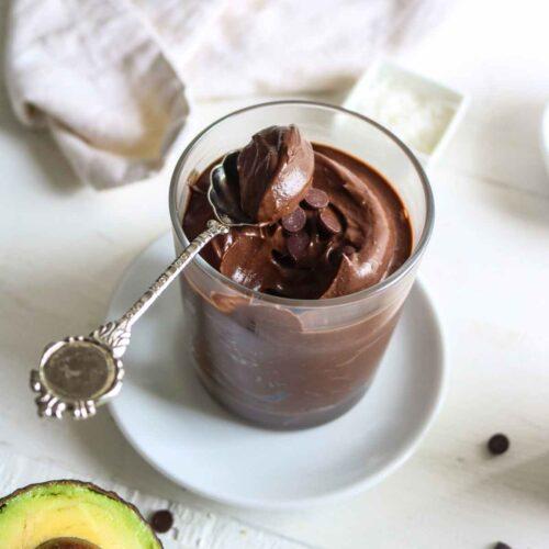A person enjoying a spoonful of chocolate avocado mousse