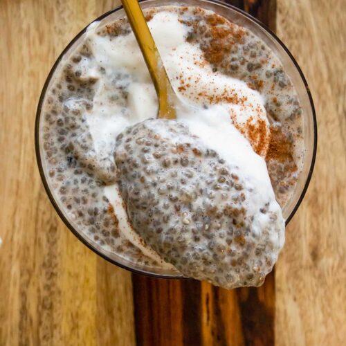 A person enjoying a bowl of chai tea chia seed pudding