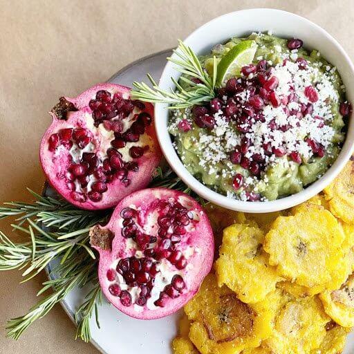 Platter of pomegranate rosemary jackfruit tacos with garnishes
