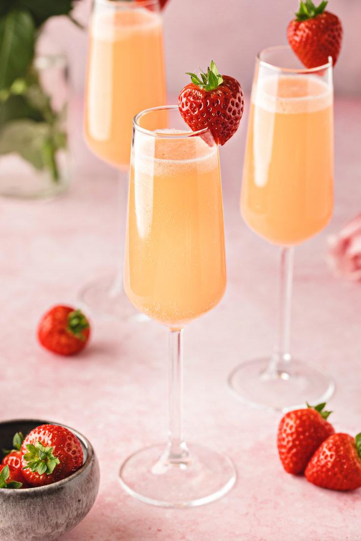 Close-up shot of Basil Strawberry Mimosa in a champagne flute