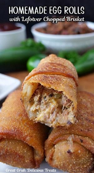 Close up of someone taking a bite of a smoked brisket egg roll
