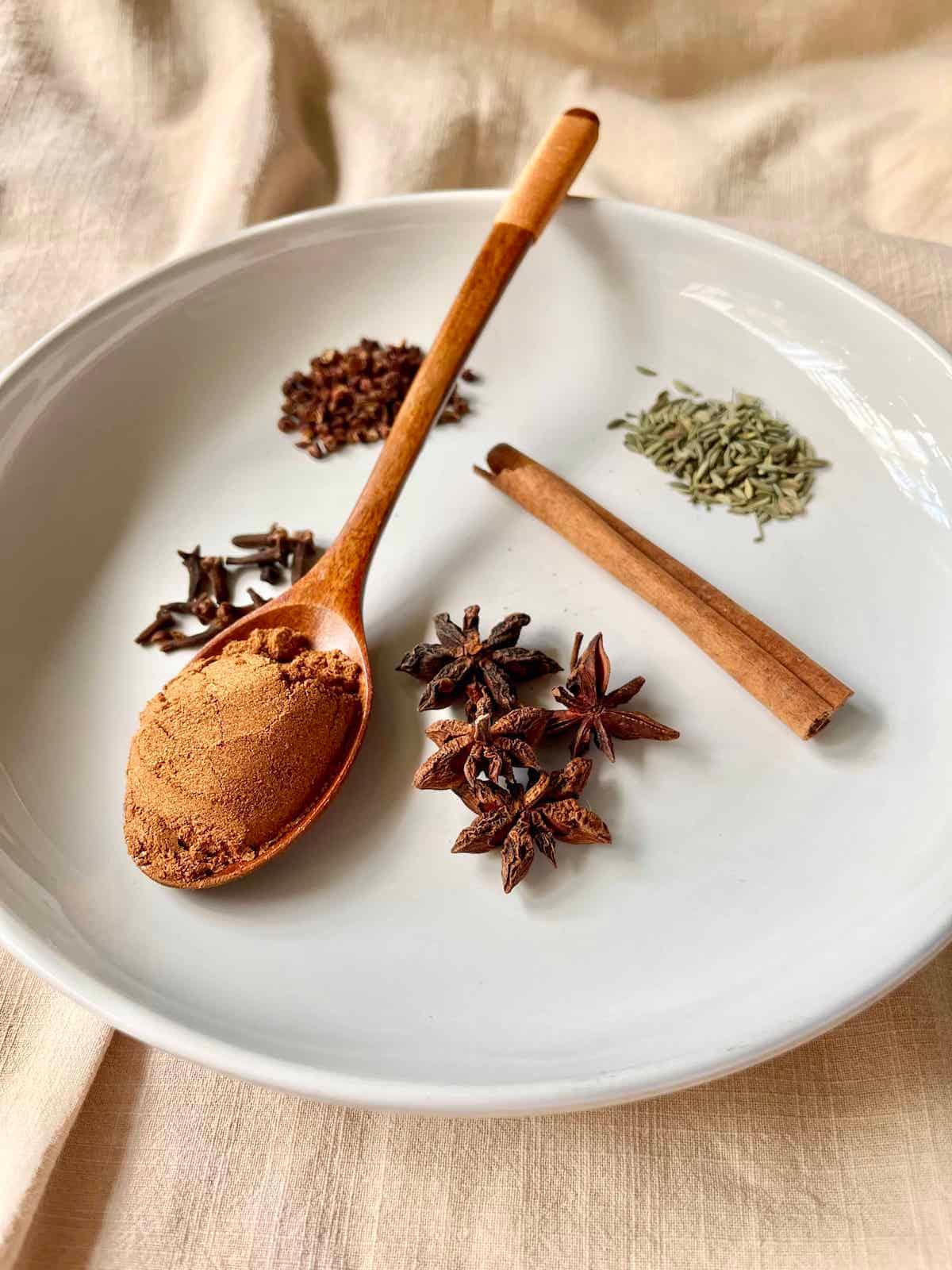 Various spices in a bowl, including five-spice powder