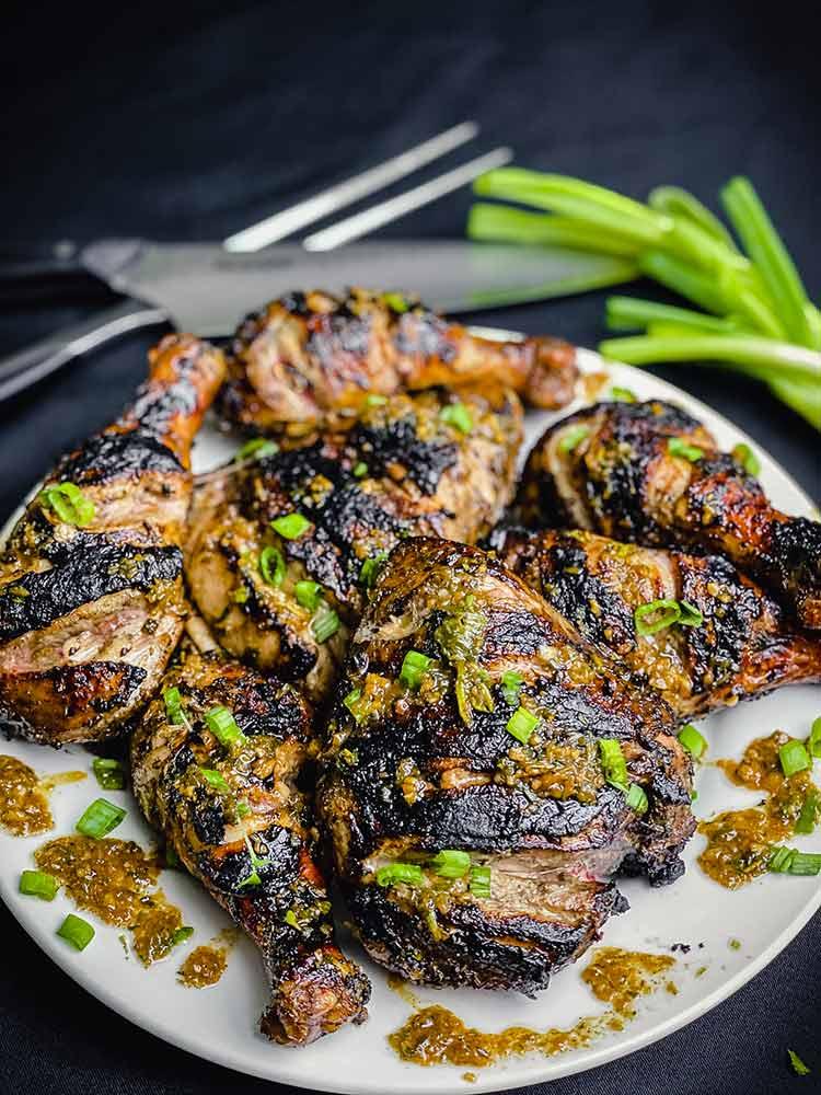 A plate of jerk chicken tenders, garnished with fresh herbs