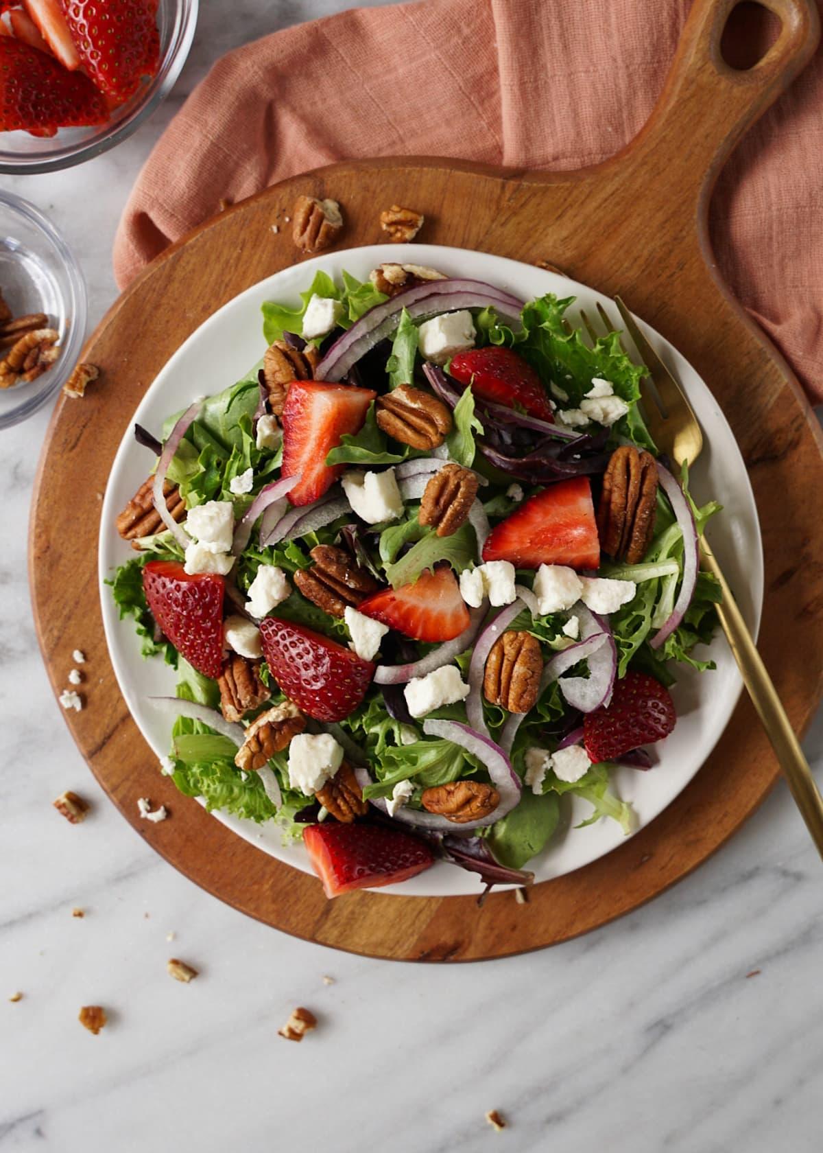 A wide shot of the strawberry salad being served at a picnic
