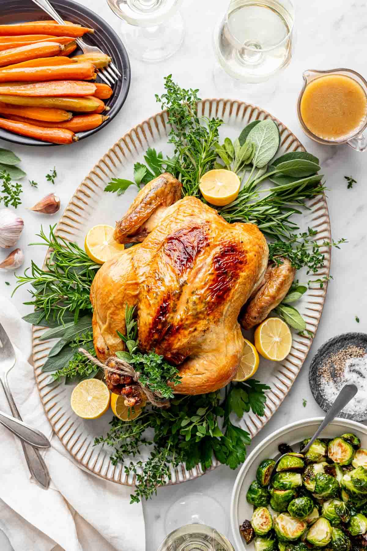 Roasted chicken served on a platter with sides