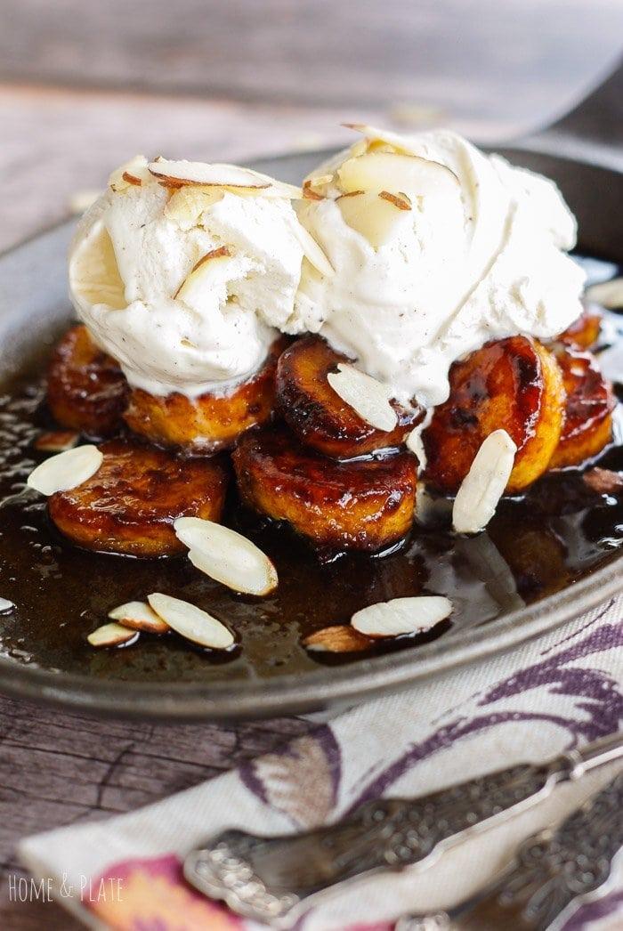 Scoops of coconut ice cream with caramelized plantains on top