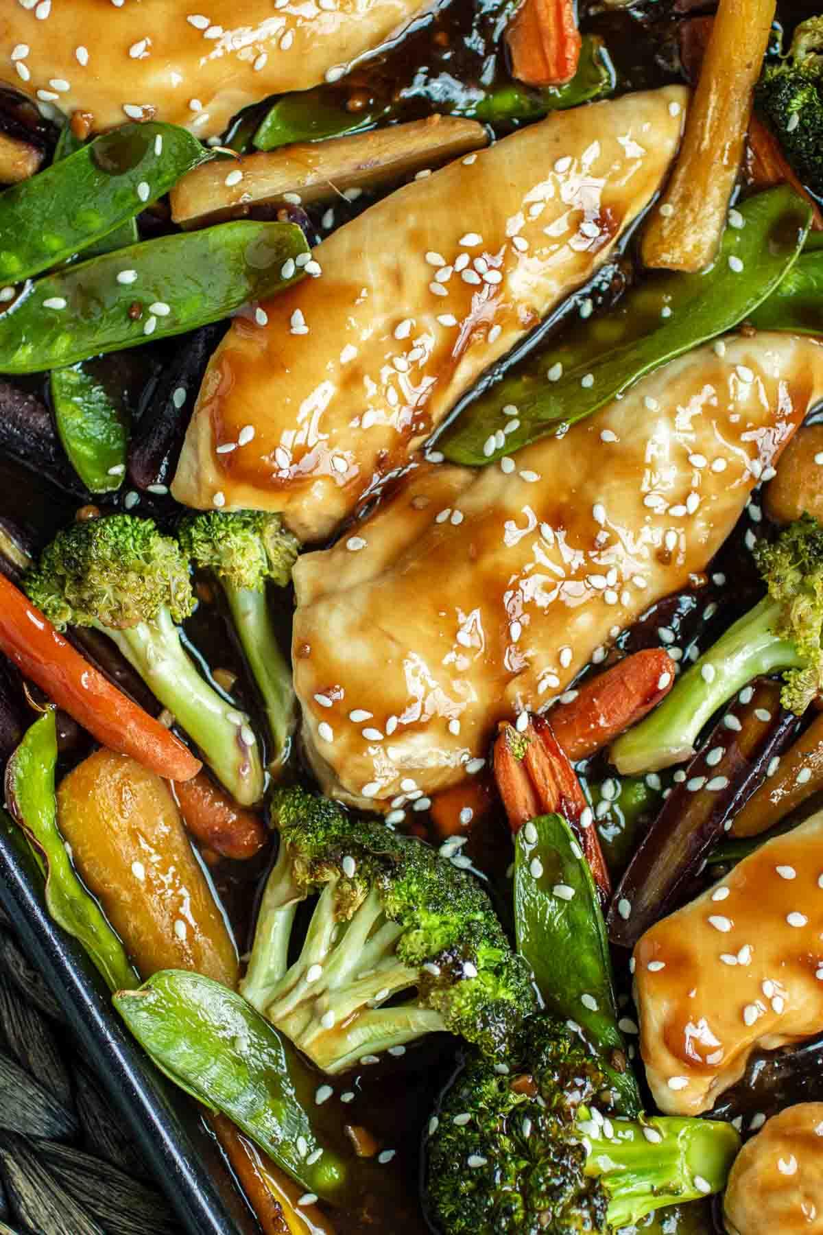 Close-up shot of honey garlic glazed chicken and broccoli on a sheet pan