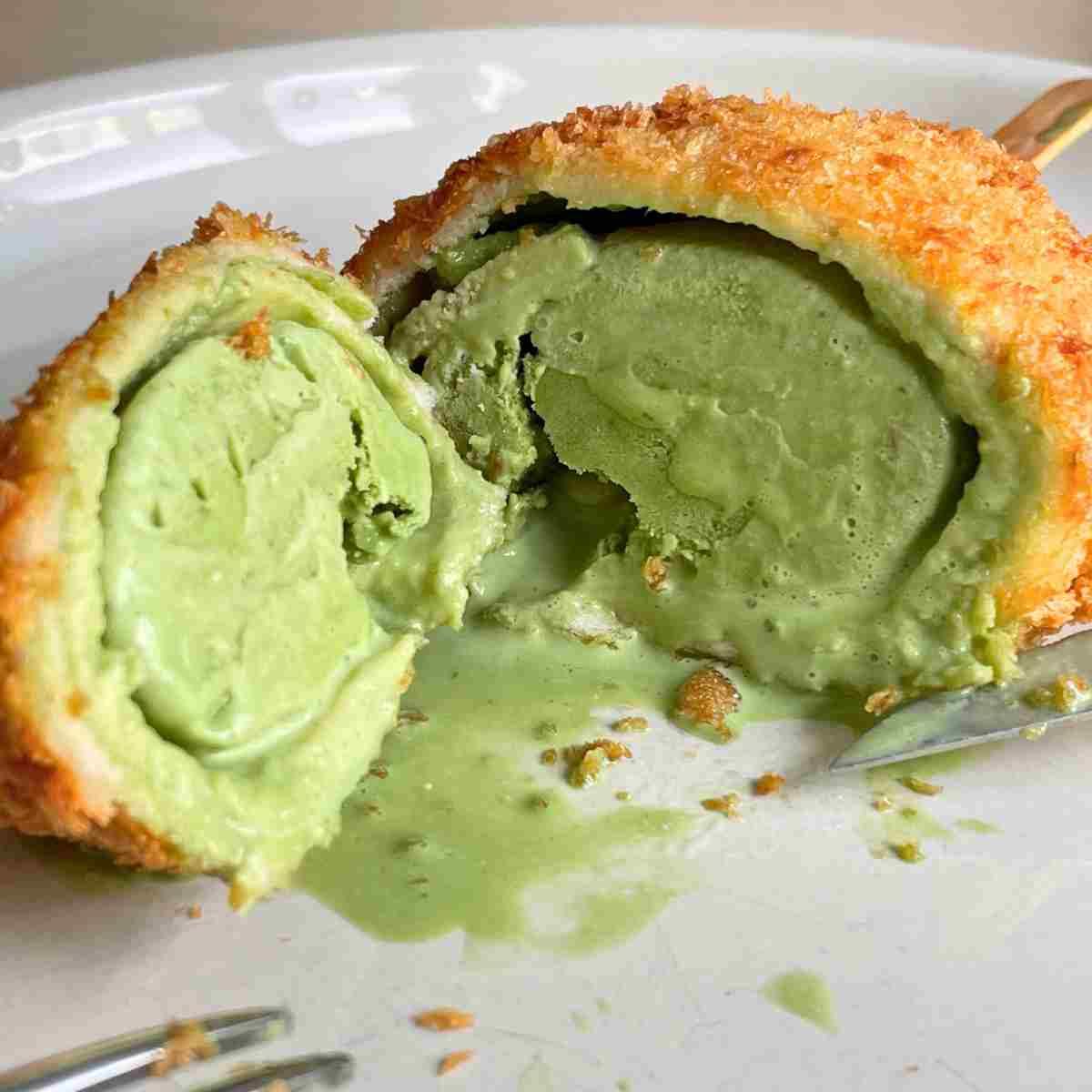 Scoops of green tea ice cream coated in crispy golden tempura batter
