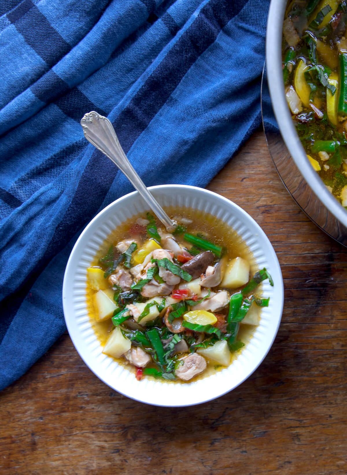 A person enjoying a bowl of Keto Vegetarian Soup in a cozy setting