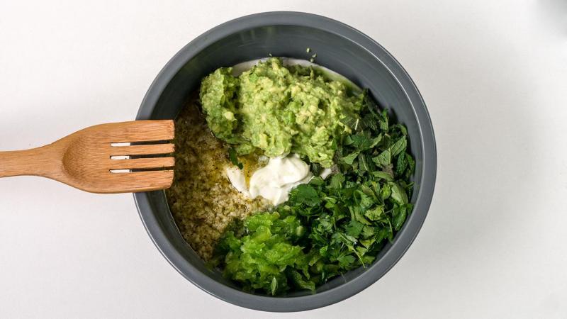aerial view of a bowl of green apple and ginger tzatziki surrounded by fresh ingredients