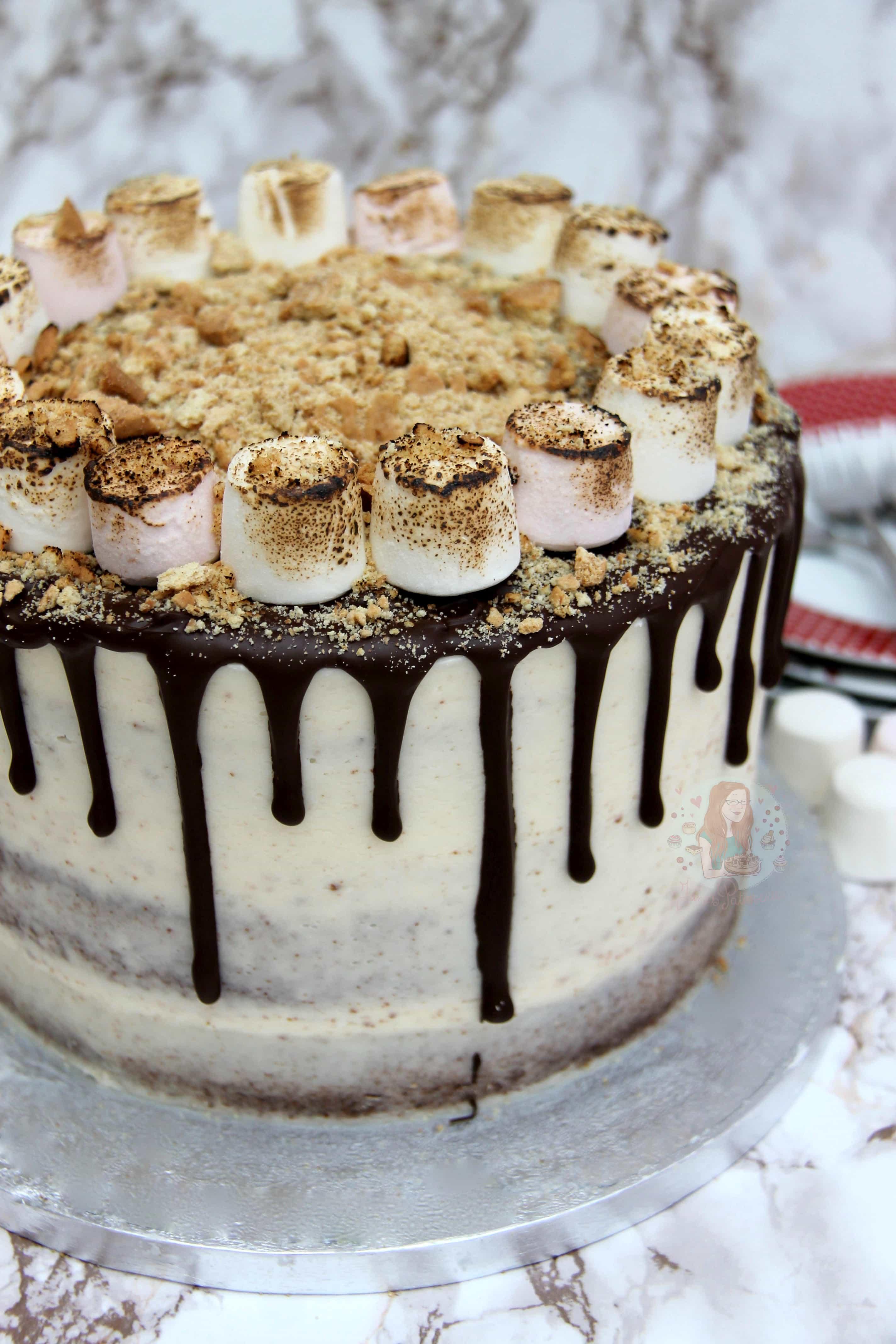 A whole s'mores cake decorated with mini marshmallows