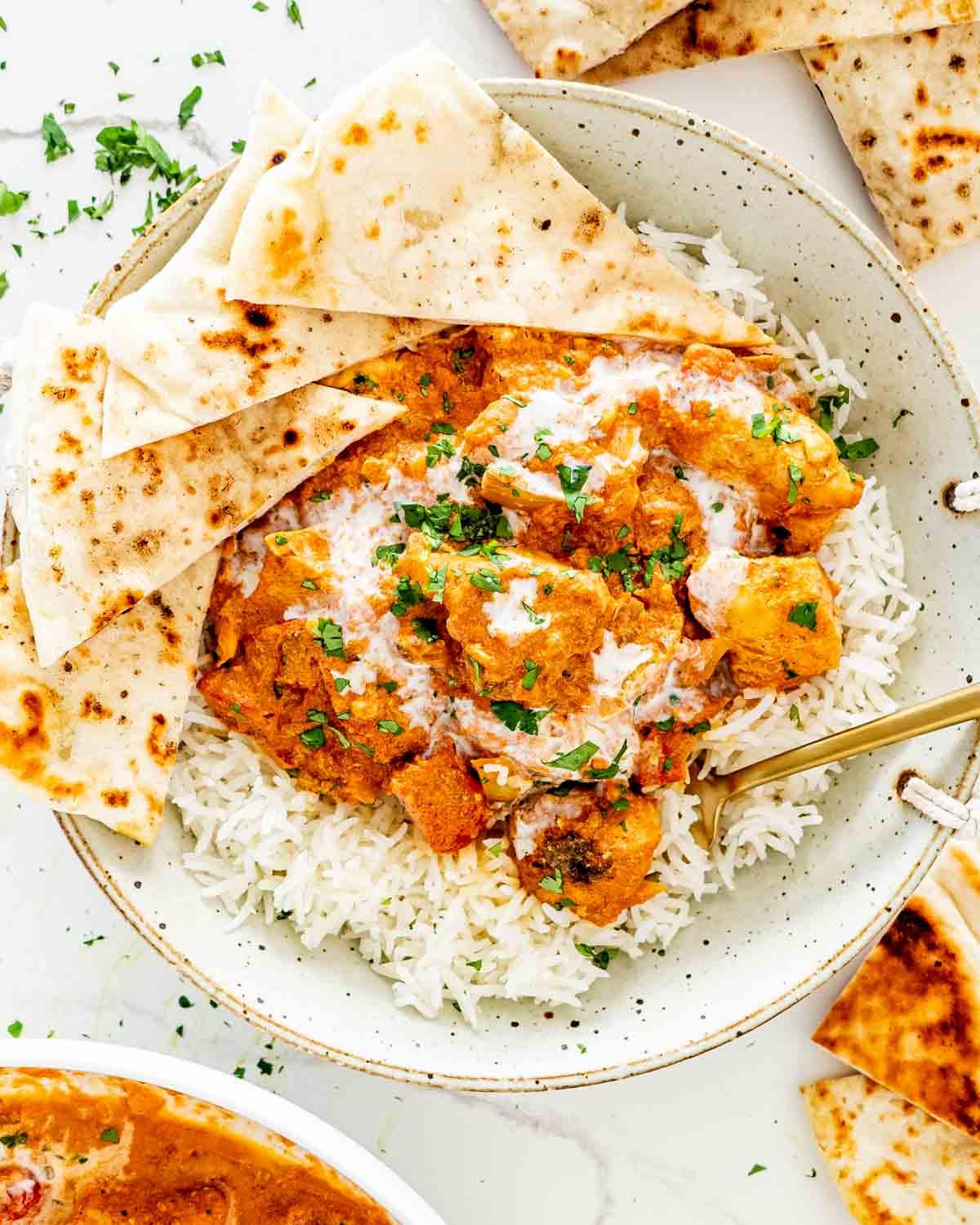 Close-up shot of a flavorful Instant Pot Tikka Masala Stew with chicken and rice, garnished with cilantro