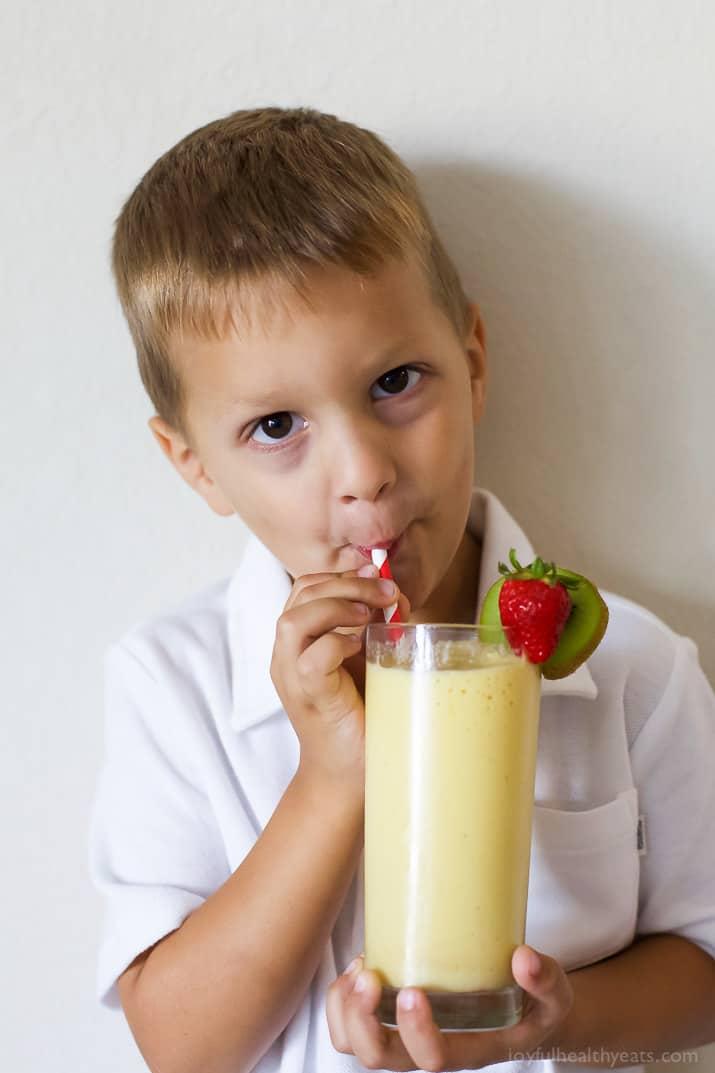 child helping to make tropical mango tango smoothie