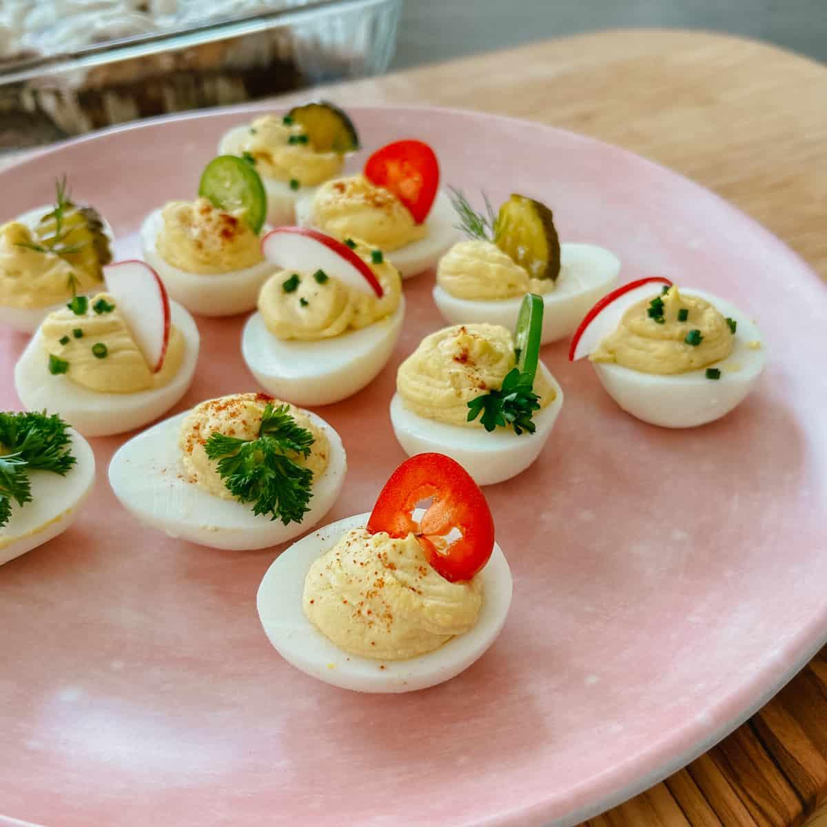 A platter of Gin & Tonic Deviled Eggs, beautifully garnished and styled
