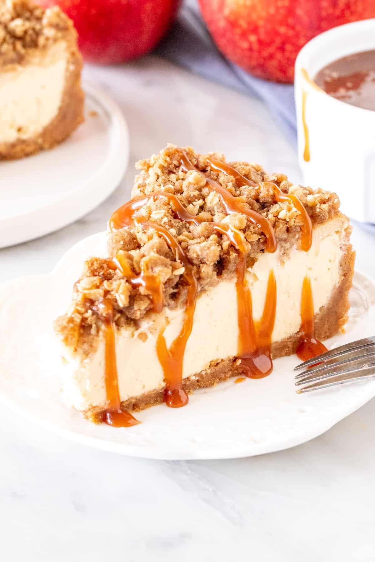 Person slicing a piece of Apple Crisp Cheesecake