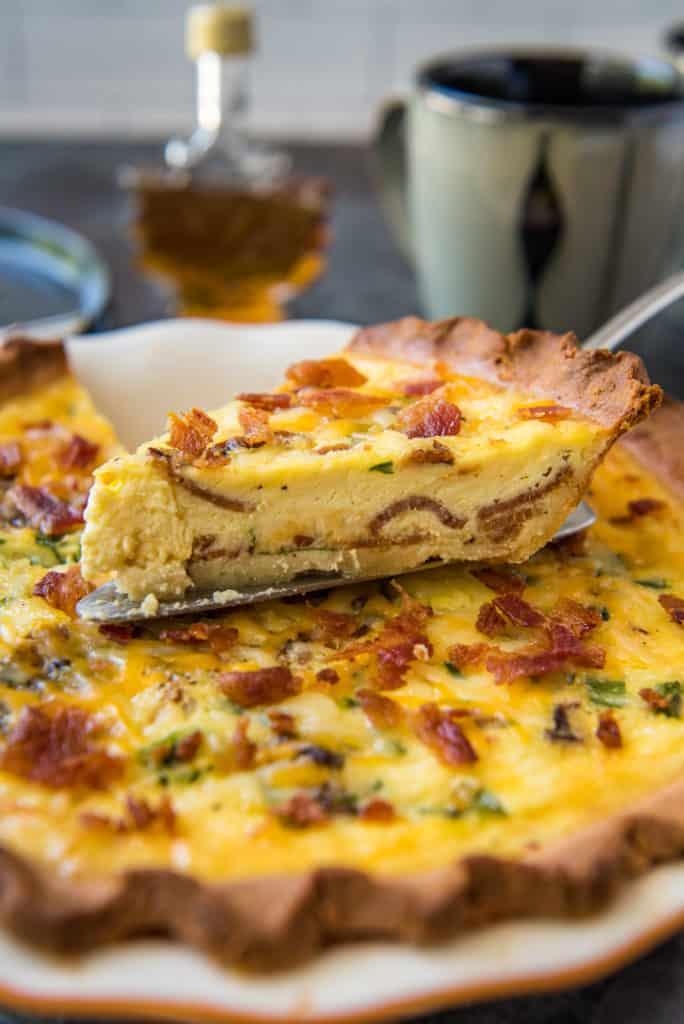 Close up of a slice of Cameroonian Quiche with Ndolé, showing the flaky crust and creamy filling
