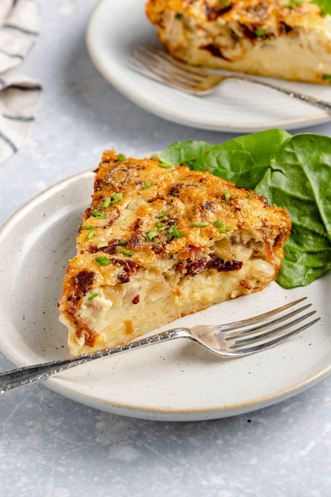 A whole crustless quiche on a table, garnished with dill